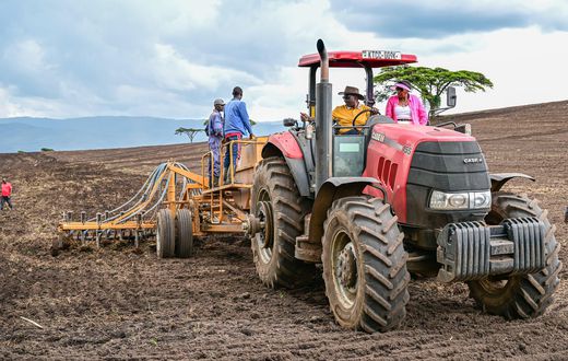 President William Ruto driving a tractor while preparing land for the planting season