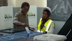 A voter casts his ballot at a polling station in Tanzania