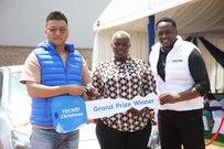 Winnie Dorah, the grand prize winner of a brand-new Mazda Demio in TECNO Kenya & Christmas Fiesta campaign, receives the car keys from Scott Liu, TECNO Kenya Country Manager, during the official handover ceremony at Garden City Mall, Nairobi.