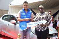 Winnie Dorah, the grand prize winner of a brand-new Mazda Demio in TECNO Kenya & Christmas Fiesta campaign, receives the car keys from Scott Liu, TECNO Kenya Country Manager, during the official handover ceremony at Garden City Mall, Nairobi.