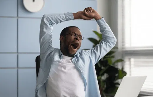 A man tired in the office depicting Ergophobia