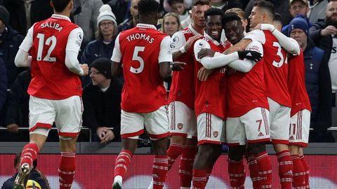 Arsenal players celebrate after taking the lead against Tottenham