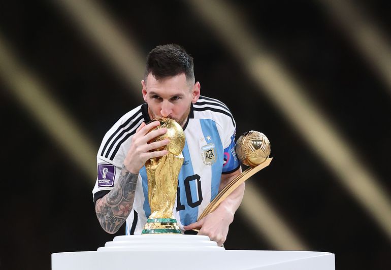 Lionel Messi with the World Cup trophy after leading Argentina to victory against France in the final in Qatar